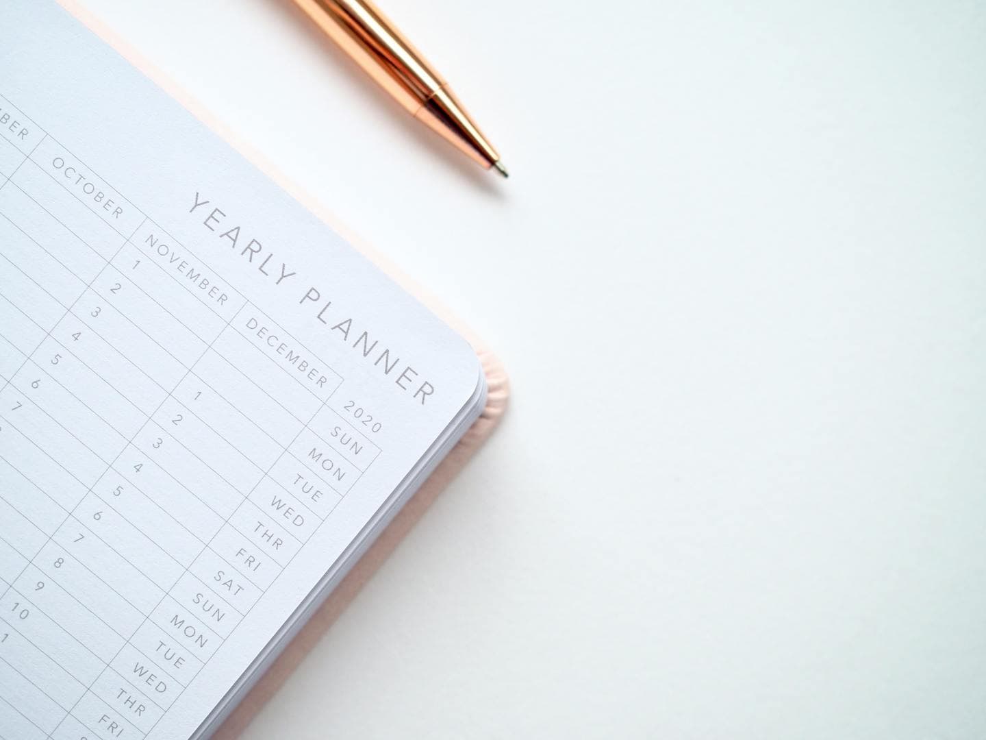 Open planner and pen on a desk for scheduling court reporter appointments